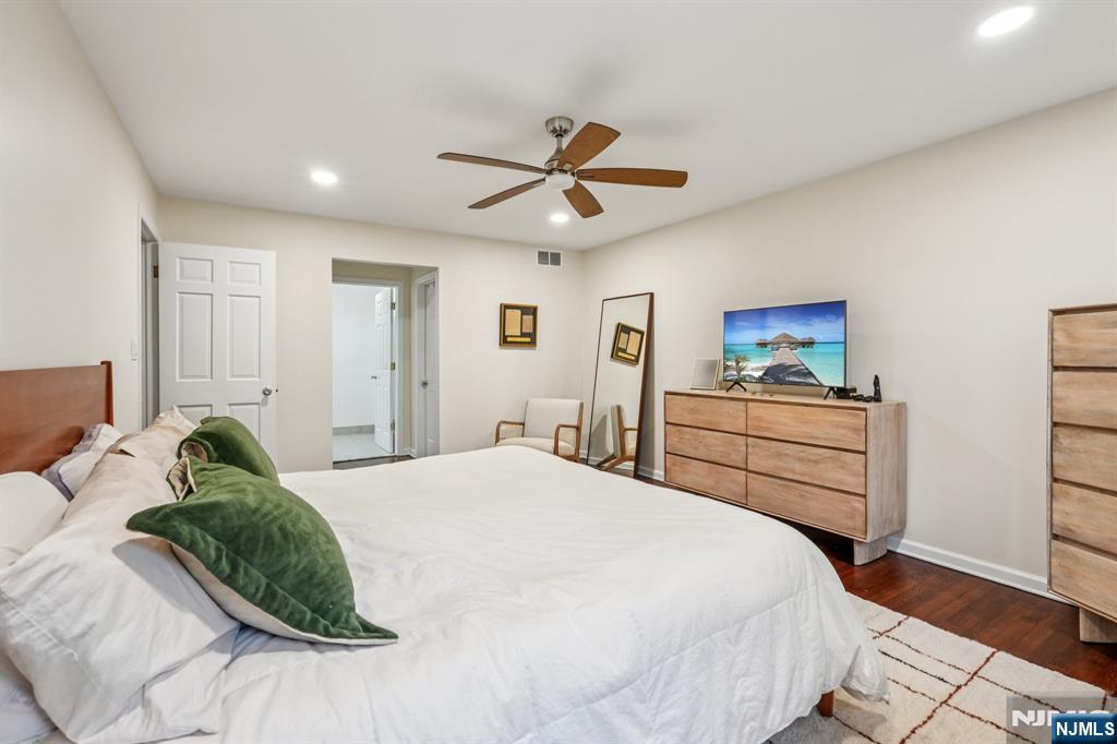 215 Readington Road Somerville, NJ 08876 - Photo 15 of 26 a bedroom with a bed and a chandelier