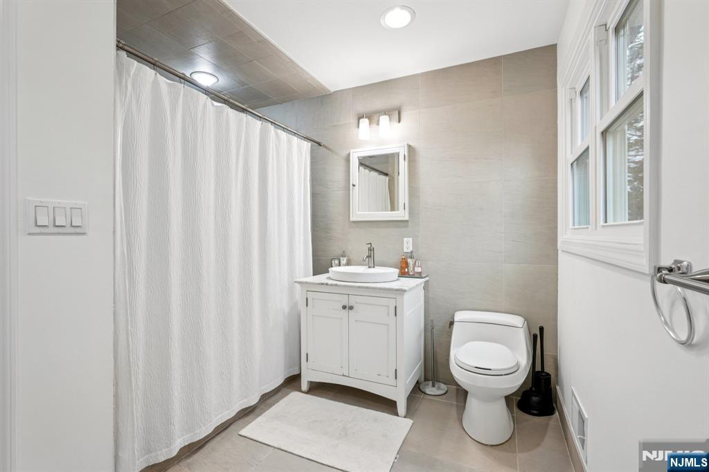 215 Readington Road Somerville, NJ 08876 - Photo 16 of 26 a white toilet sitting next to a bathroom sink