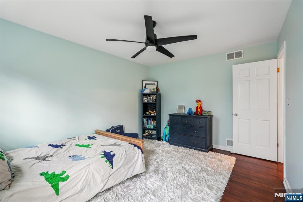 215 Readington Road Somerville, NJ 08876 - Photo 19 of 26 a bedroom with a bed and wooden floor