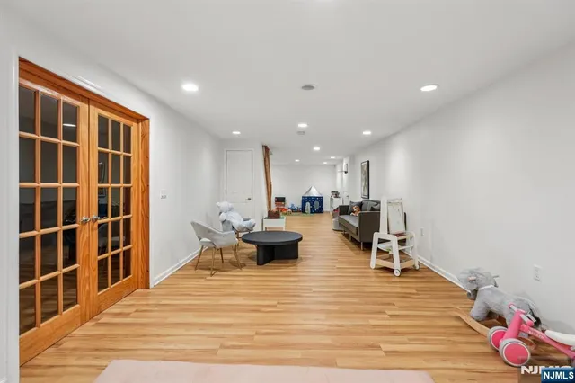 a living room with furniture a rug and white walls