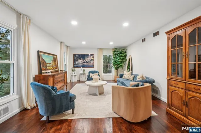 a living room with fireplace furniture and a large window
