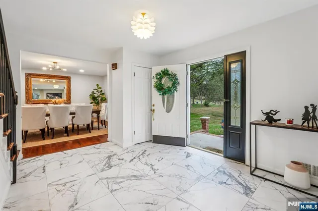 a view of a big room with windows and chandelier