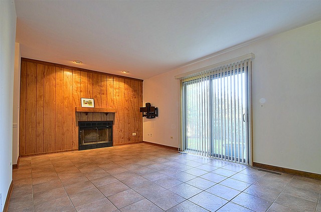 715 Roberts Lane Batavia, IL 60510 - Photo 11 of 24 a view of an empty room with a fireplace and a window