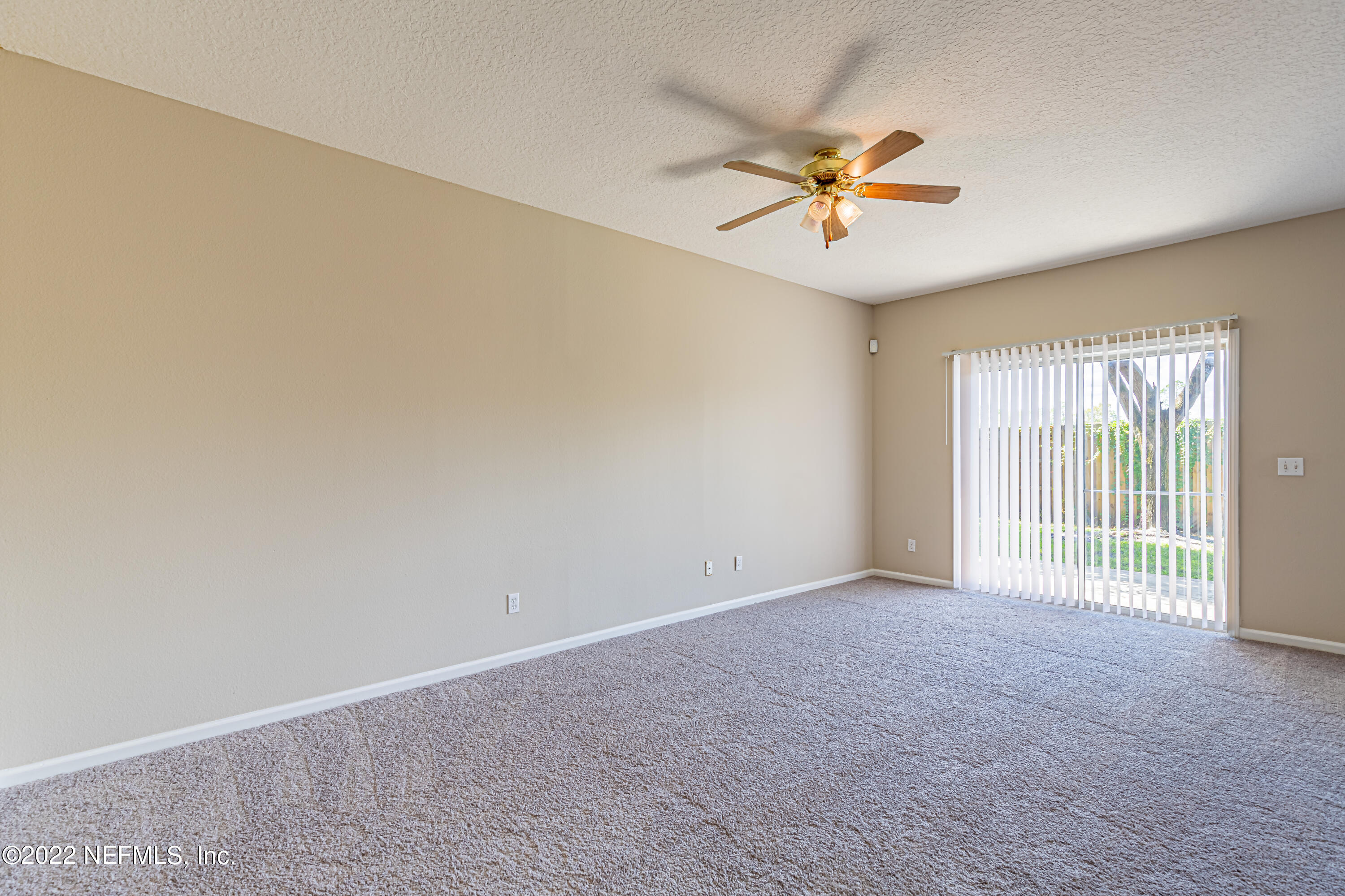 5260 Collins Road, Unit 607 Jacksonville, FL 32244 - Photo 11 of 41 a view of a livingroom with a ceiling fan and window