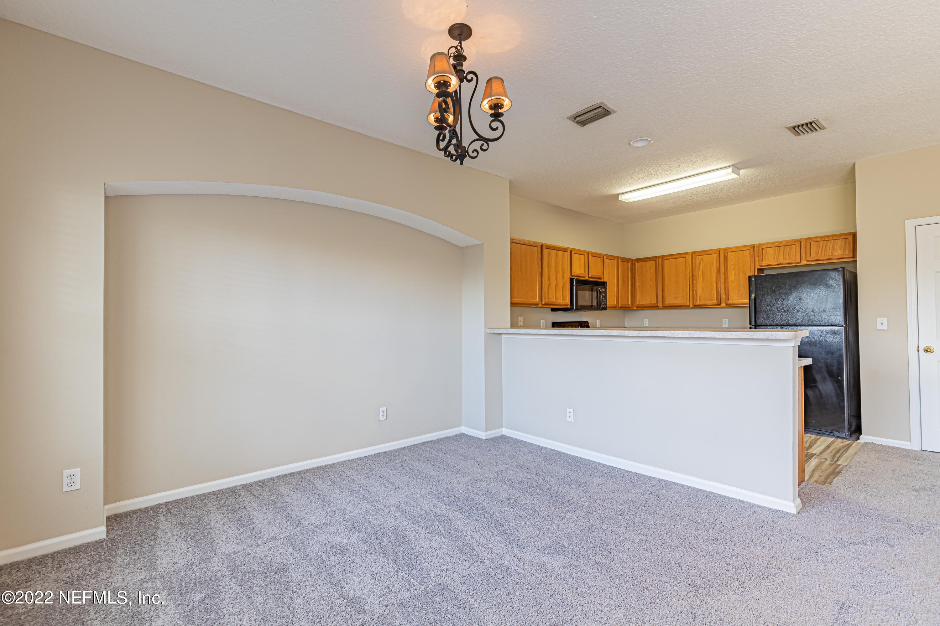 5260 Collins Road, Unit 607 Jacksonville, FL 32244 - Photo 13 of 41 a view of a kitchen with a sink and dishwasher refrigerator freezer