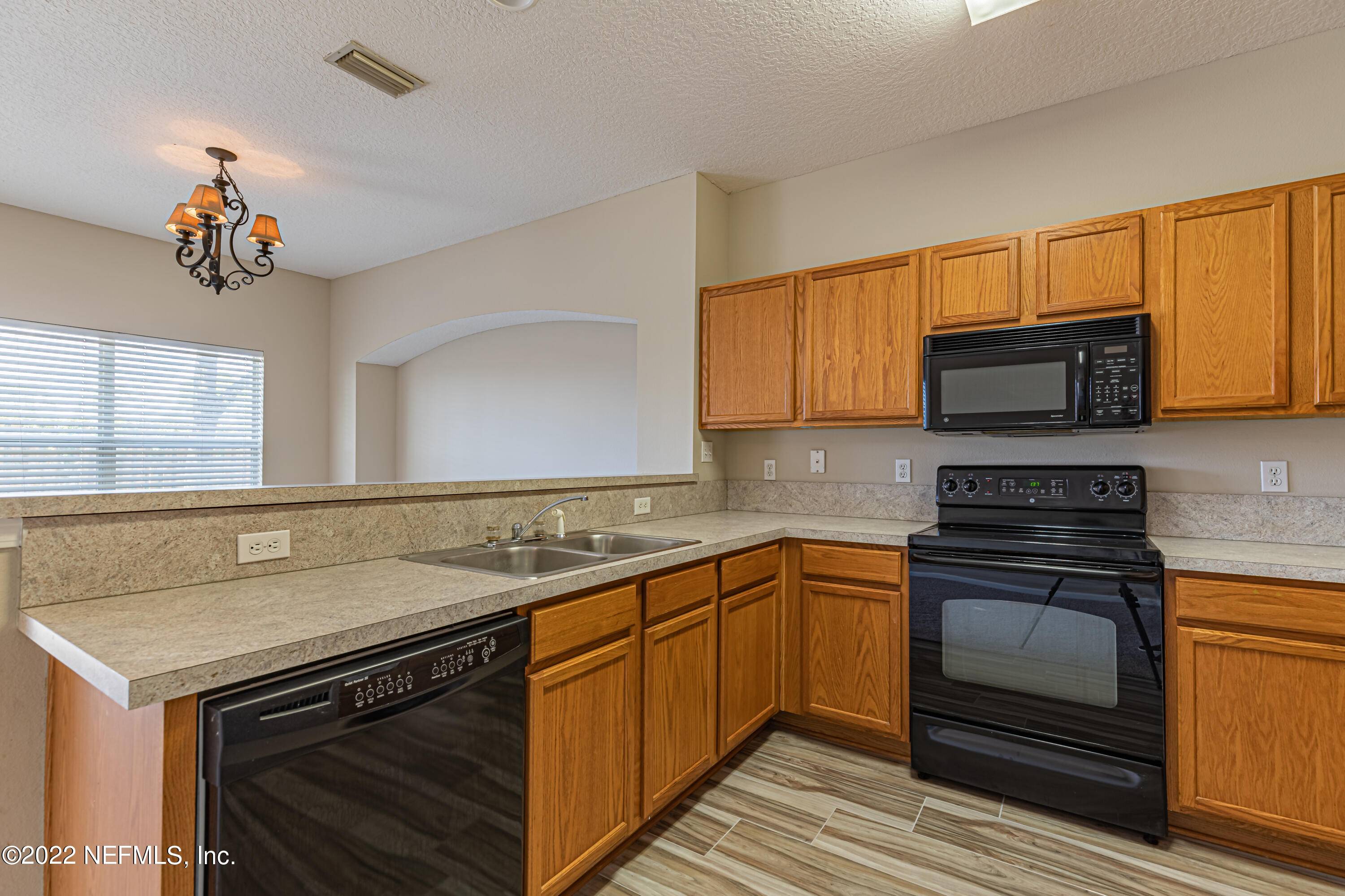 5260 Collins Road, Unit 607 Jacksonville, FL 32244 - Photo 15 of 41 a kitchen with stainless steel appliances granite countertop a stove microwave and cabinets