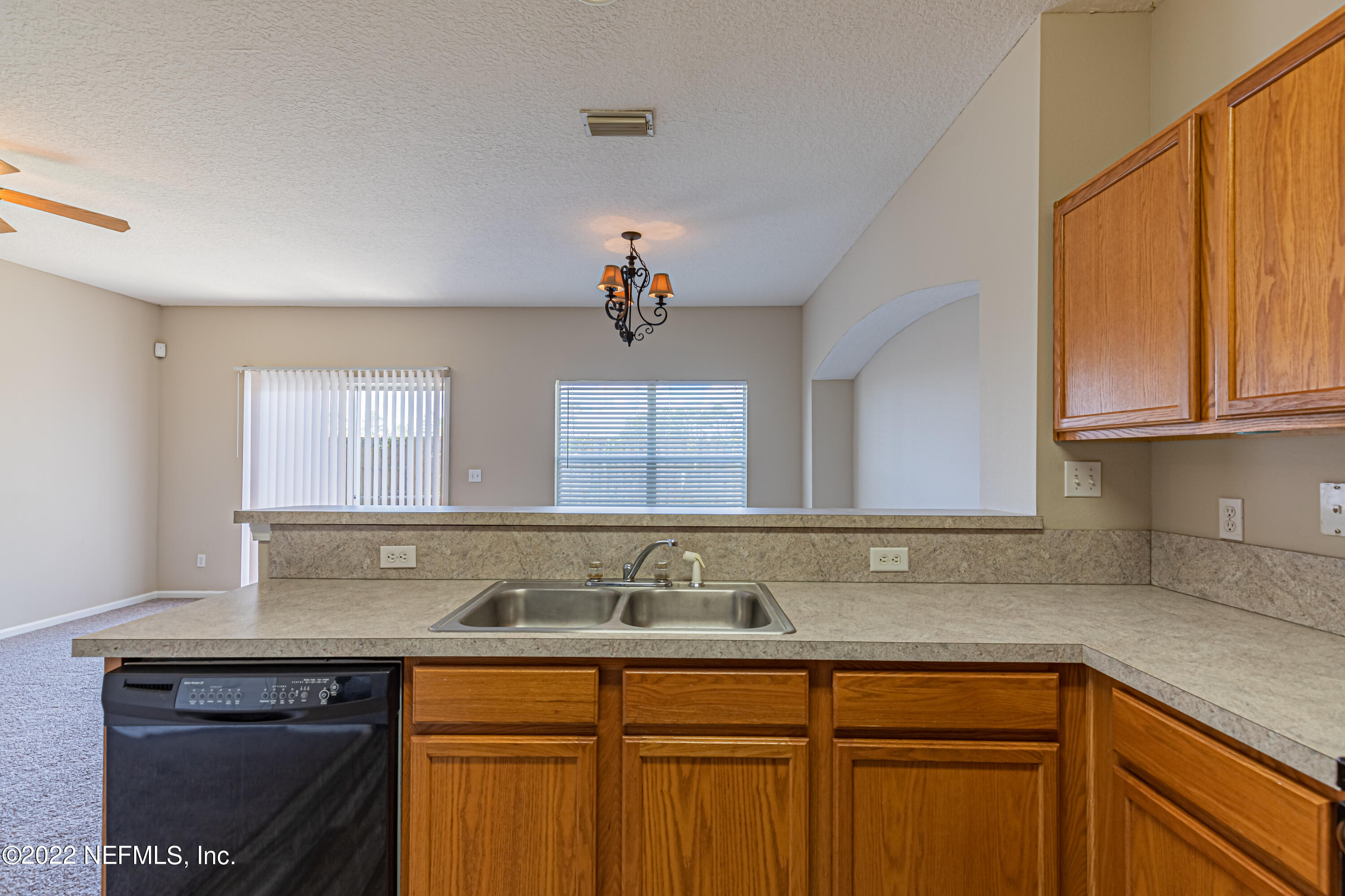 5260 Collins Road, Unit 607 Jacksonville, FL 32244 - Photo 17 of 41 a kitchen with stainless steel appliances granite countertop a sink a stove and a microwave