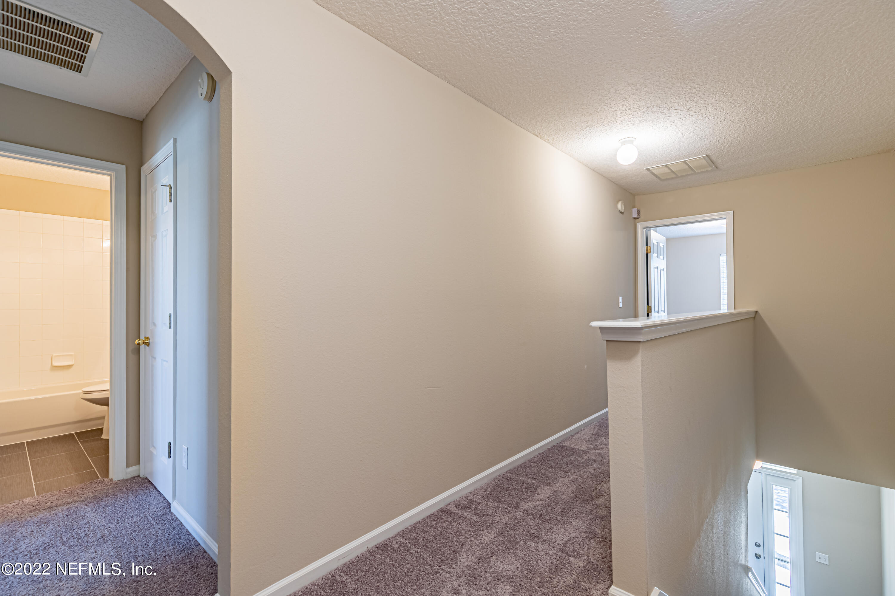 5260 Collins Road, Unit 607 Jacksonville, FL 32244 - Photo 18 of 41 a view of a hallway with closet and bathroom