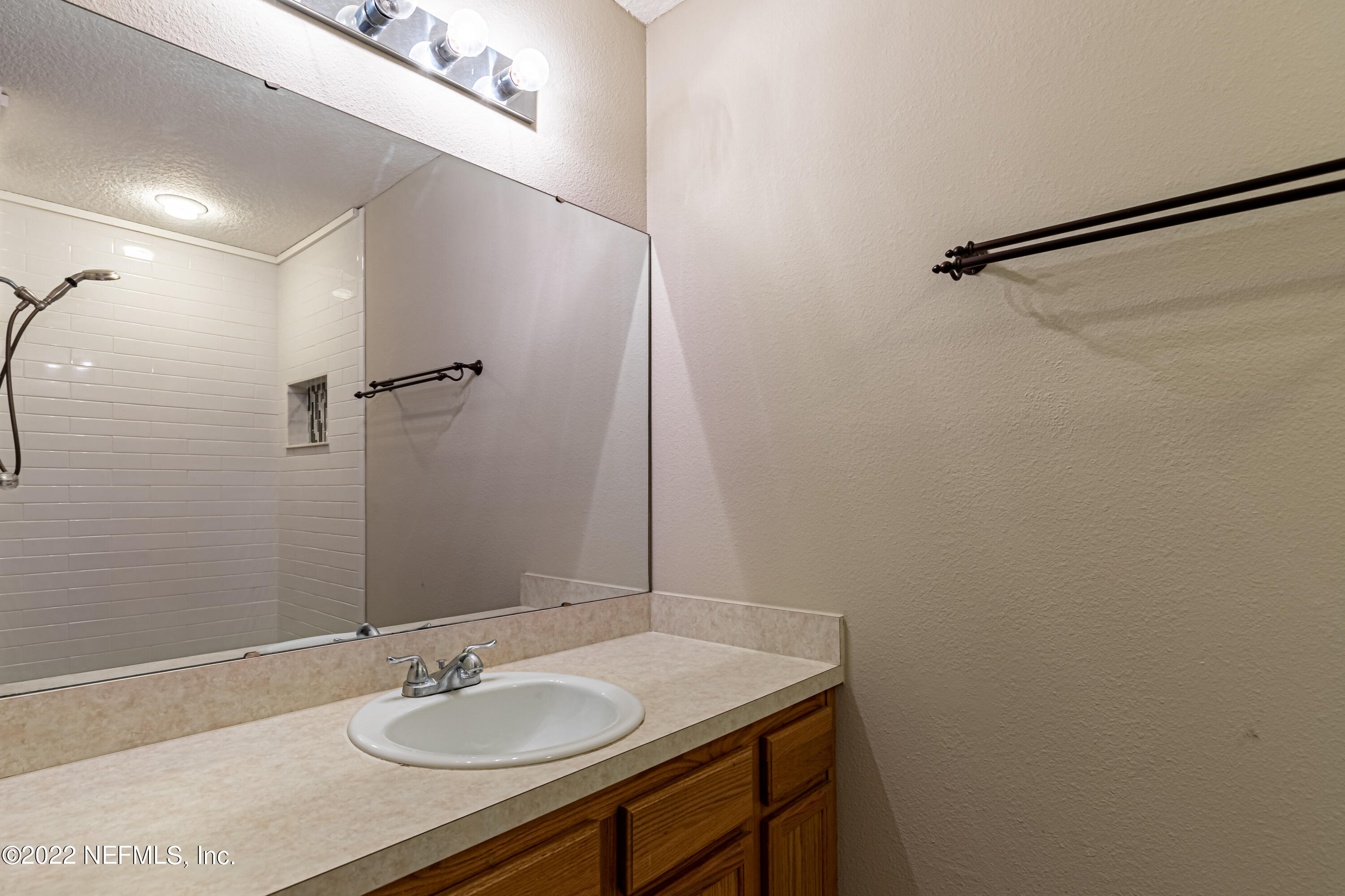 5260 Collins Road, Unit 607 Jacksonville, FL 32244 - Photo 27 of 41 a bathroom with a sink and a mirror