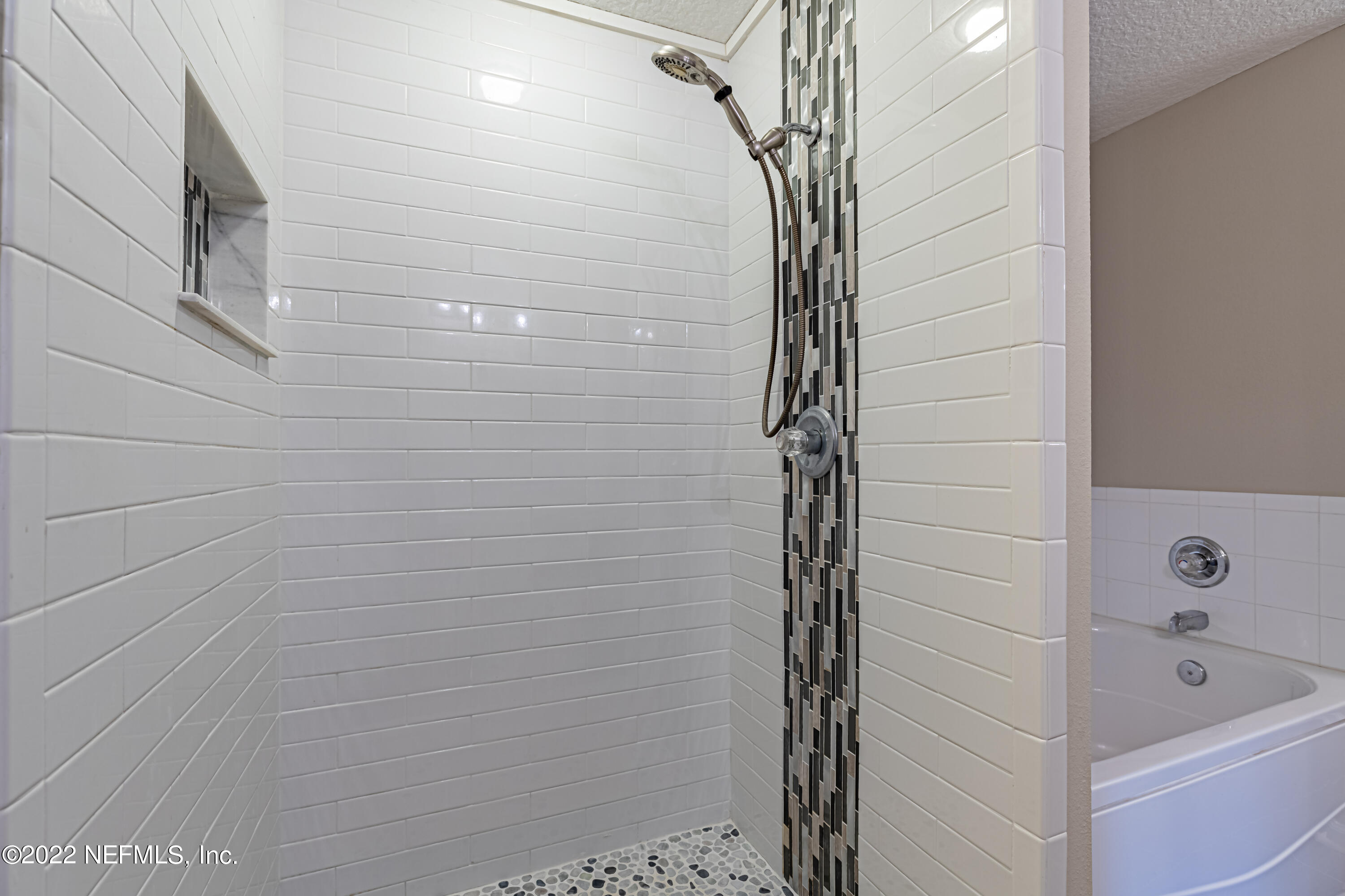 5260 Collins Road, Unit 607 Jacksonville, FL 32244 - Photo 28 of 41 a bathroom with a bathtub and shower