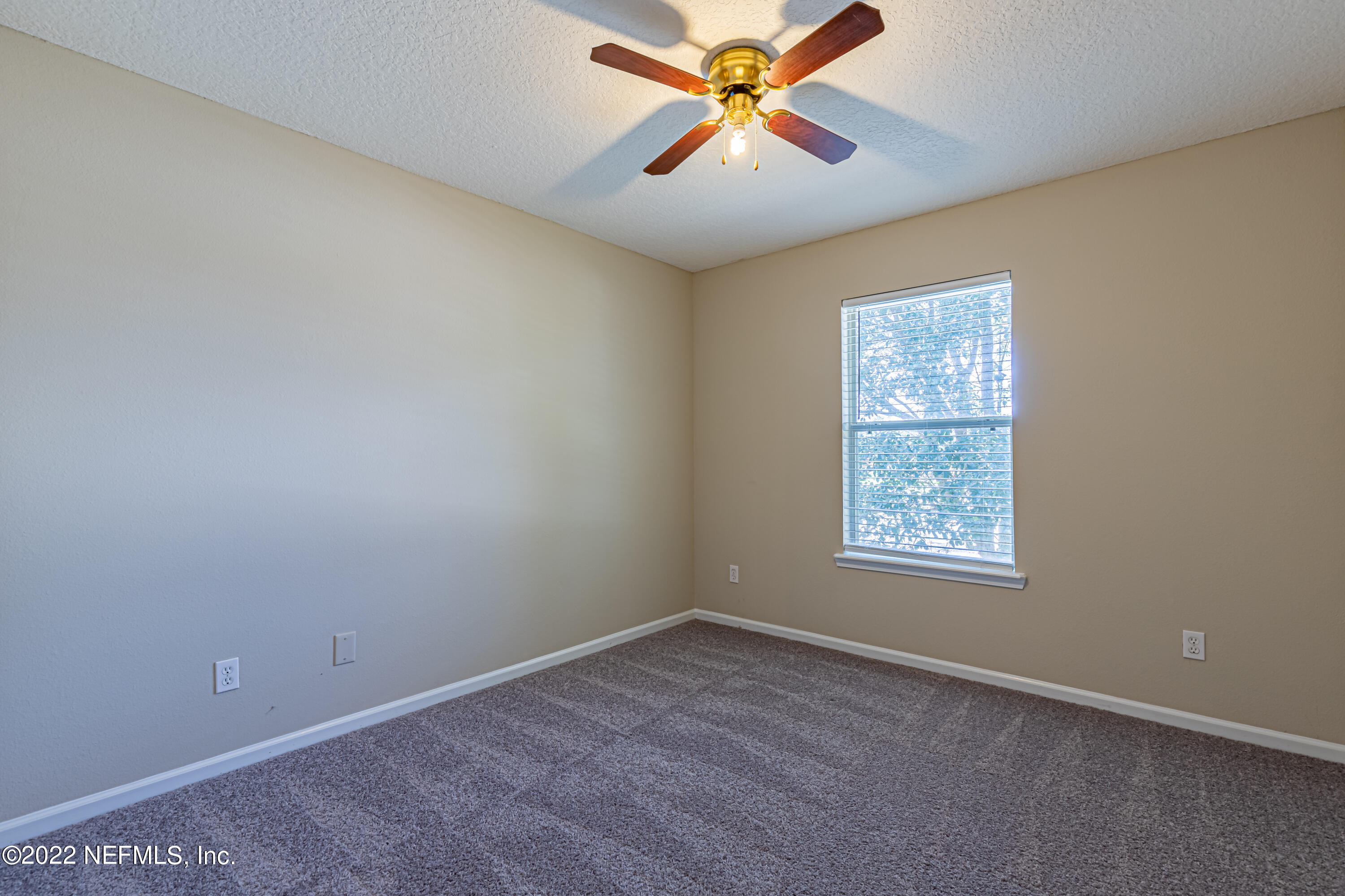 5260 Collins Road, Unit 607 Jacksonville, FL 32244 - Photo 30 of 41 an empty room with windows and fan