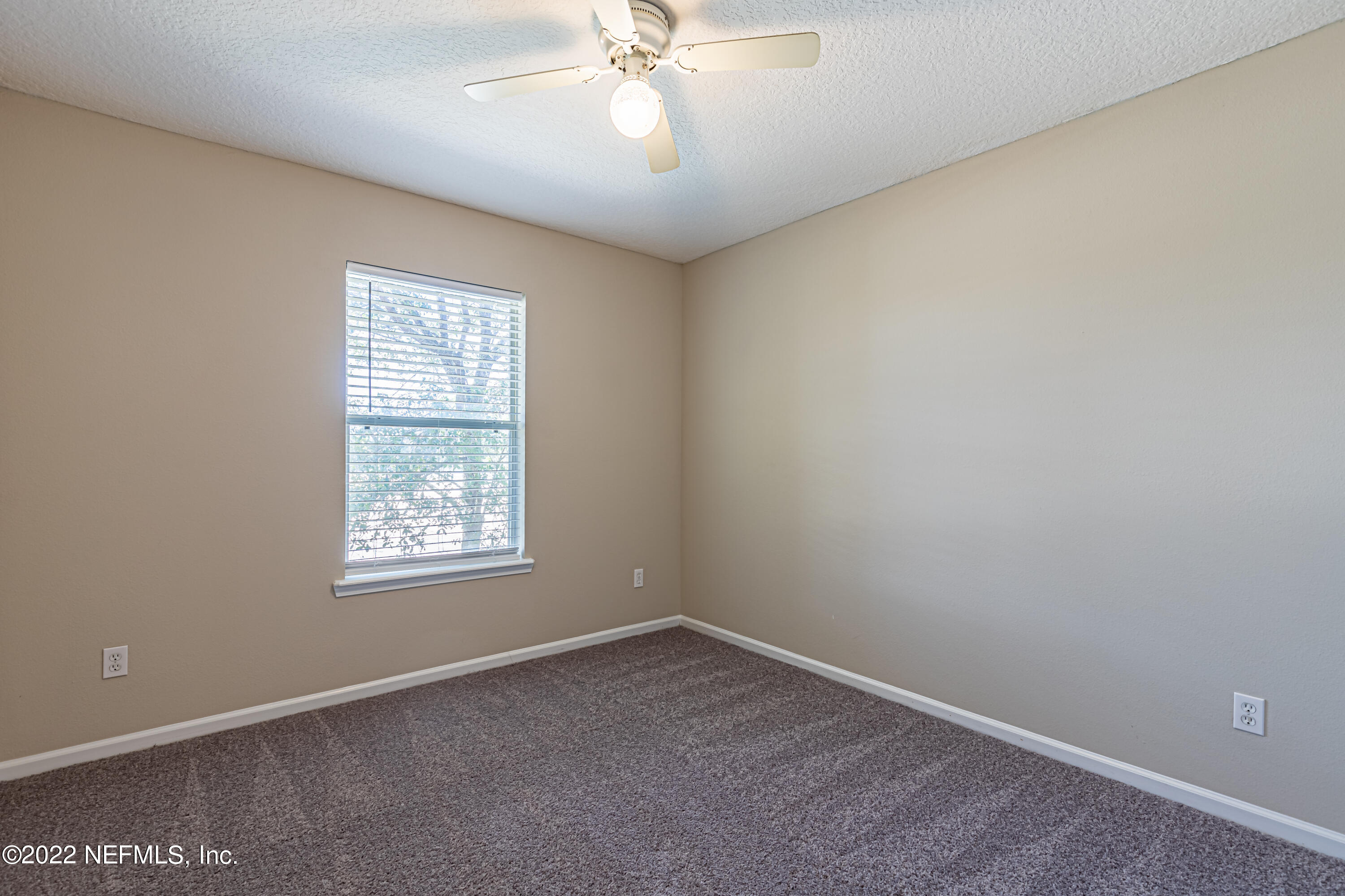 5260 Collins Road, Unit 607 Jacksonville, FL 32244 - Photo 31 of 41 an empty room with a window and a fan
