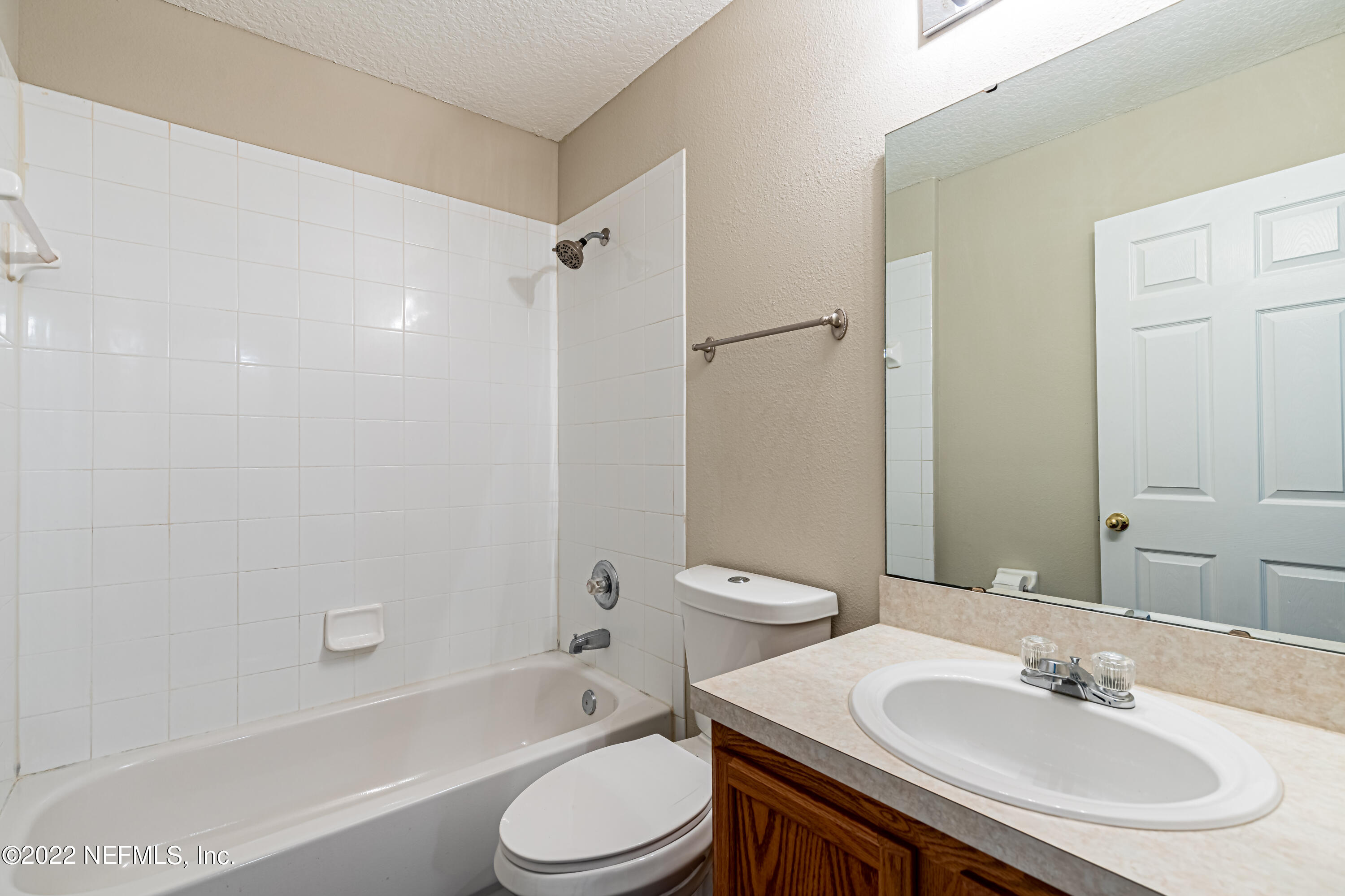 5260 Collins Road, Unit 607 Jacksonville, FL 32244 - Photo 32 of 41 a bathroom with a sink a toilet and shower