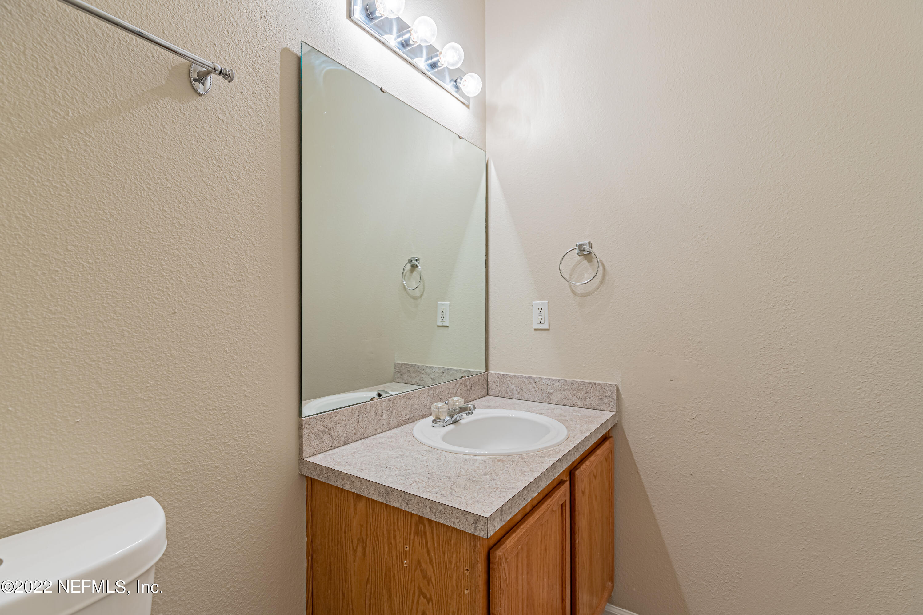 5260 Collins Road, Unit 607 Jacksonville, FL 32244 - Photo 33 of 41 a bathroom with a sink vanity and a mirror