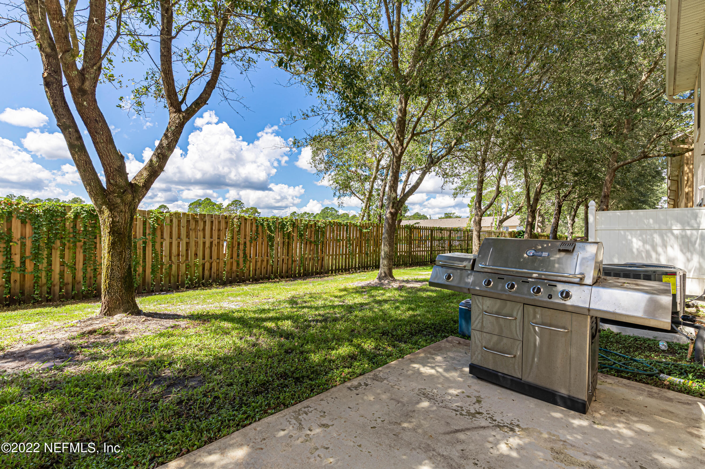 5260 Collins Road, Unit 607 Jacksonville, FL 32244 - Photo 34 of 41 a view of a backyard with trees