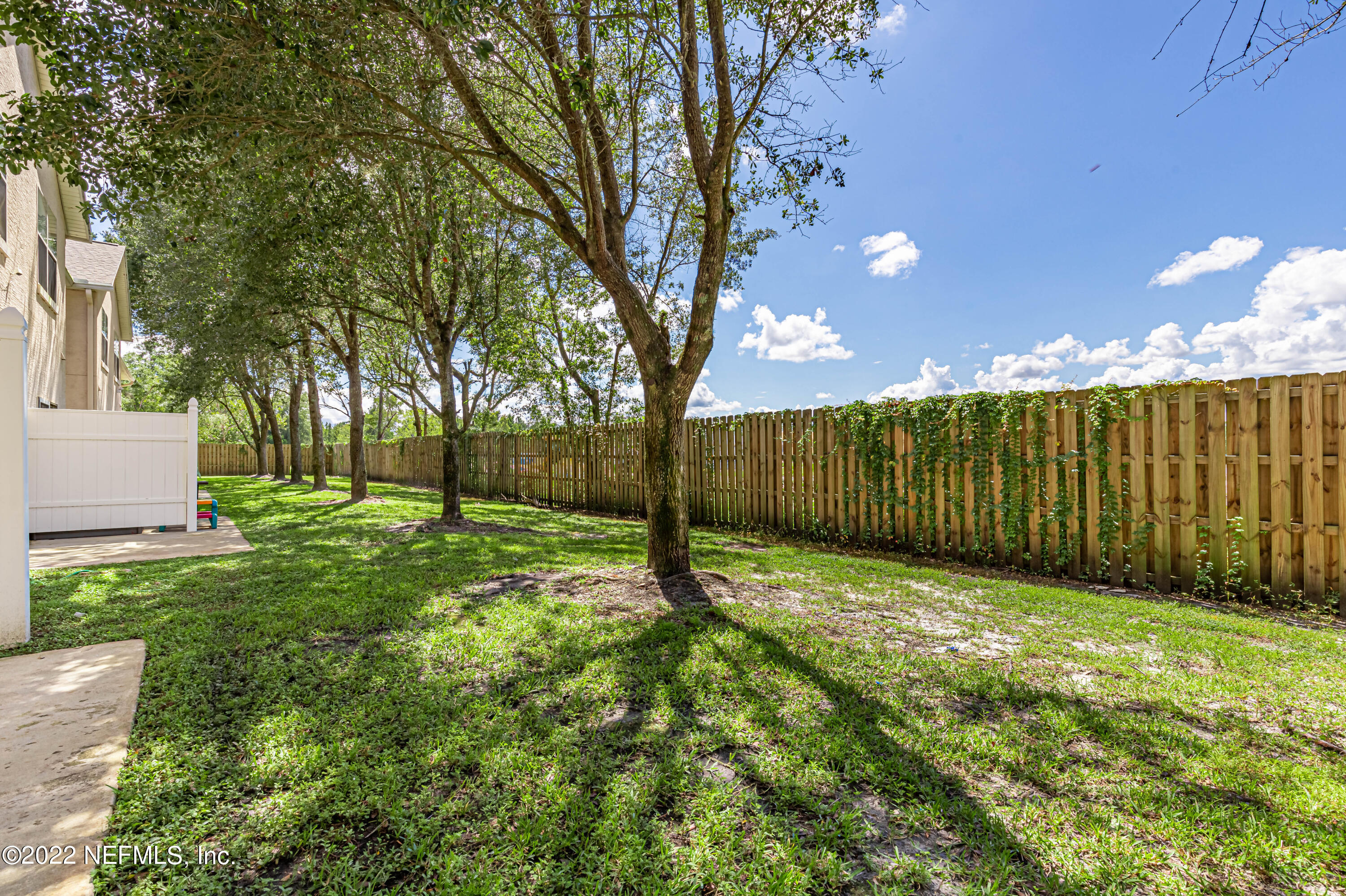 5260 Collins Road, Unit 607 Jacksonville, FL 32244 - Photo 37 of 41 a view of a yard with wooden fence