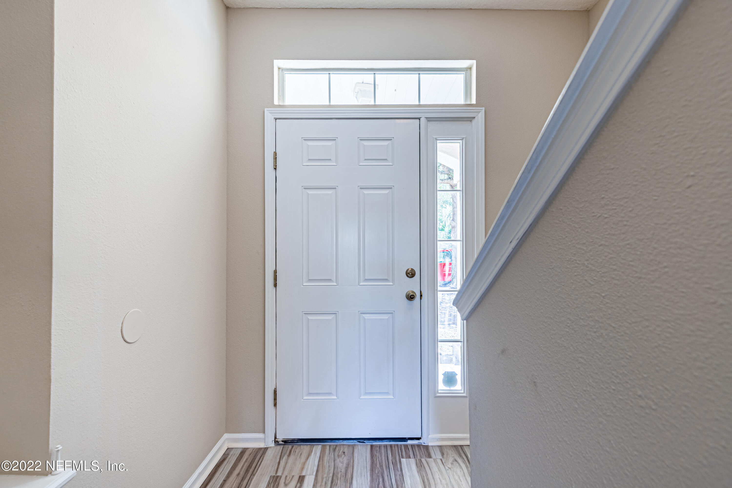 5260 Collins Road, Unit 607 Jacksonville, FL 32244 - Photo 5 of 41 a view of a hallway with wooden floor and staircase