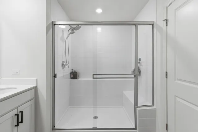a bathroom with a glass shower door