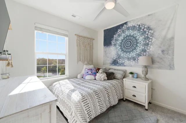 a bedroom with a large bed and a window