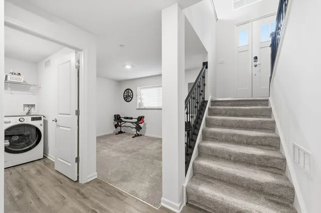 a view of a hallway with a washer and dryer