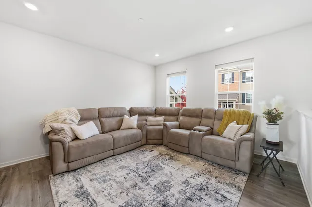 a living room with furniture and wooden floor