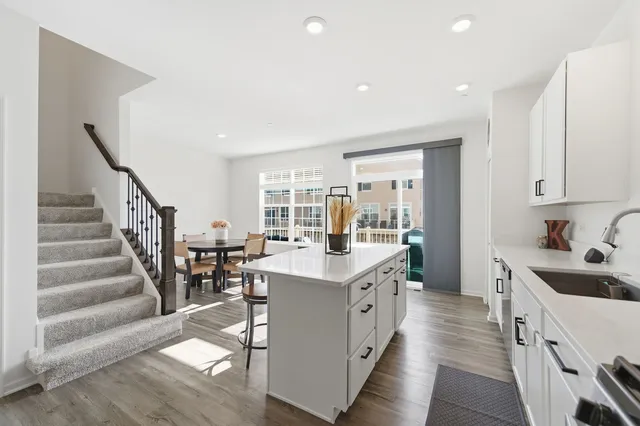 a kitchen with sink stove and cabinets