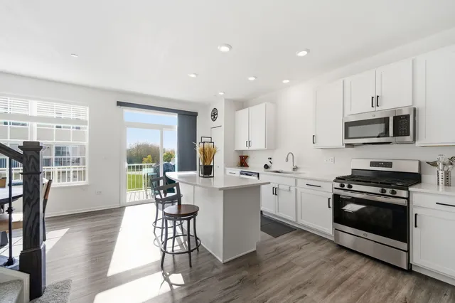 a kitchen with a stove a sink and a refrigerator