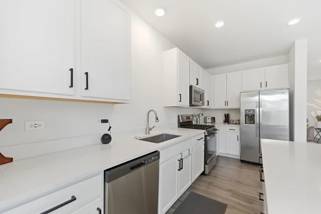 a kitchen with refrigerator cabinets and a sink