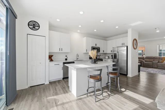 a kitchen with a refrigerator and a stove top oven