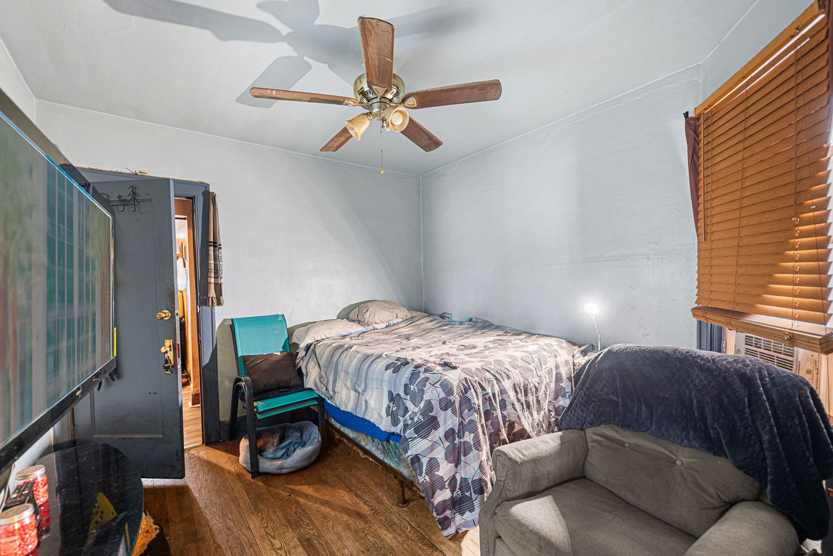 6749 South Peoria Street Chicago, IL 60621 - Photo 6 of 20 a bedroom with a bed and wooden floor