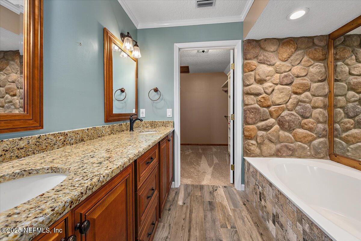 16361 Waterville Road, Unit 1 Jacksonville, FL 32226 - Photo 21 of 32 a bathroom with a granite countertop sink and a large mirror