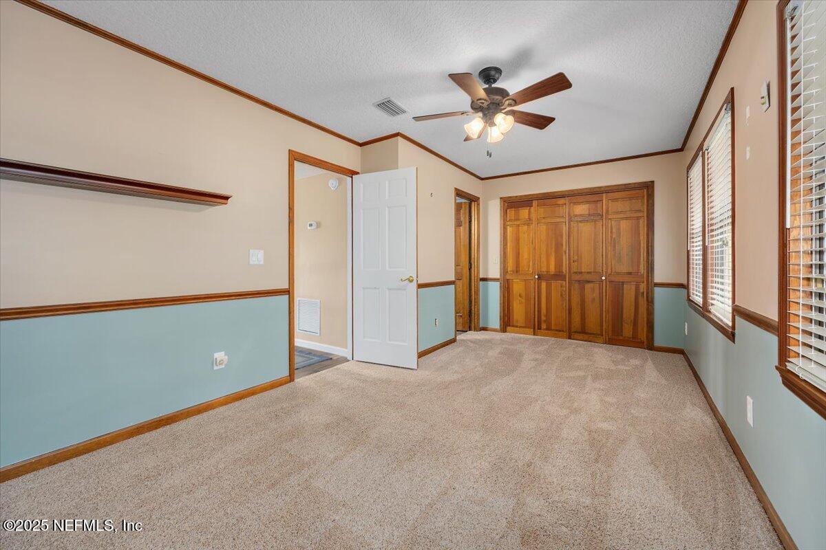 16361 Waterville Road, Unit 1 Jacksonville, FL 32226 - Photo 26 of 32 a view of an empty room with a ceiling fan