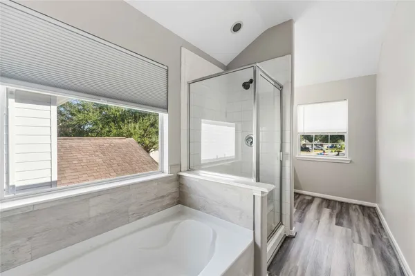 a bathroom with a bathtub and a shower