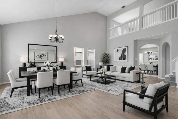 a living room with furniture and a chandelier