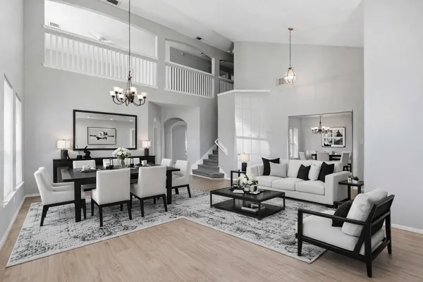 a living room with lots of furniture and view of kitchen
