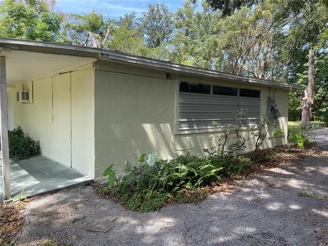 a backyard of a house with plants and trees