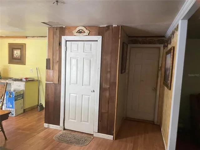 a view of hallway with wooden floor