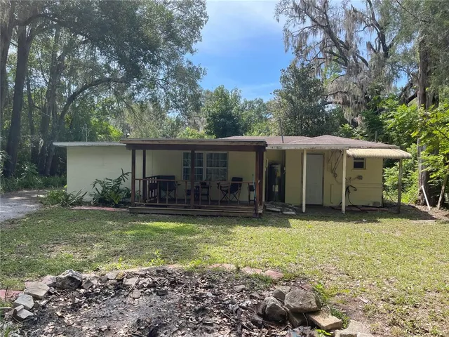 a view of a house with swimming pool and a yard
