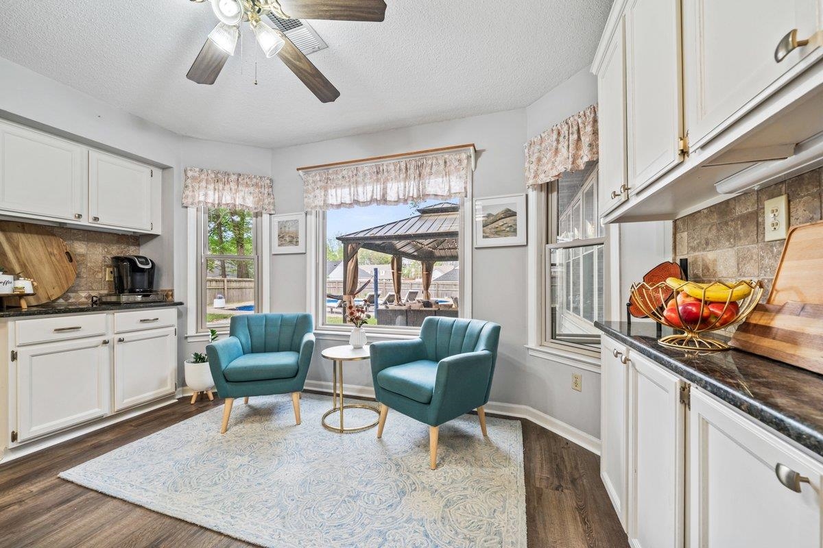 2135 Brierbrook Road Germantown, TN 38138 - Photo 11 of 25 Breakfast area with a ceiling fan, dark wood-style flooring, and a textured ceiling