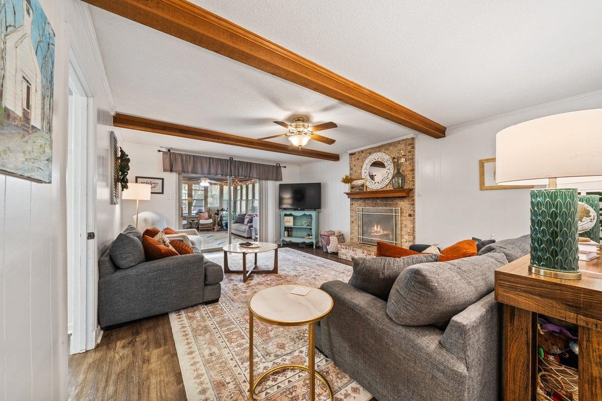 2135 Brierbrook Road Germantown, TN 38138 - Photo 12 of 25 Living area featuring wood finished floors, a fireplace, ornamental molding, beam ceiling, and ceiling fan