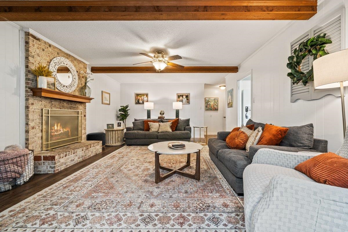 2135 Brierbrook Road Germantown, TN 38138 - Photo 14 of 25 Living area with beam ceiling, ceiling fan, ornamental molding, a fireplace, and a textured ceiling