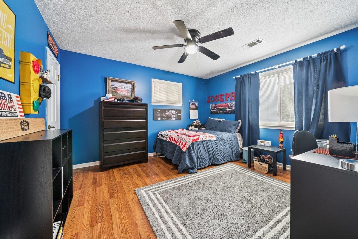 2135 Brierbrook Road Germantown, TN 38138 - Photo 18 of 25 Bedroom featuring light wood finished floors, a ceiling fan, and a textured ceiling