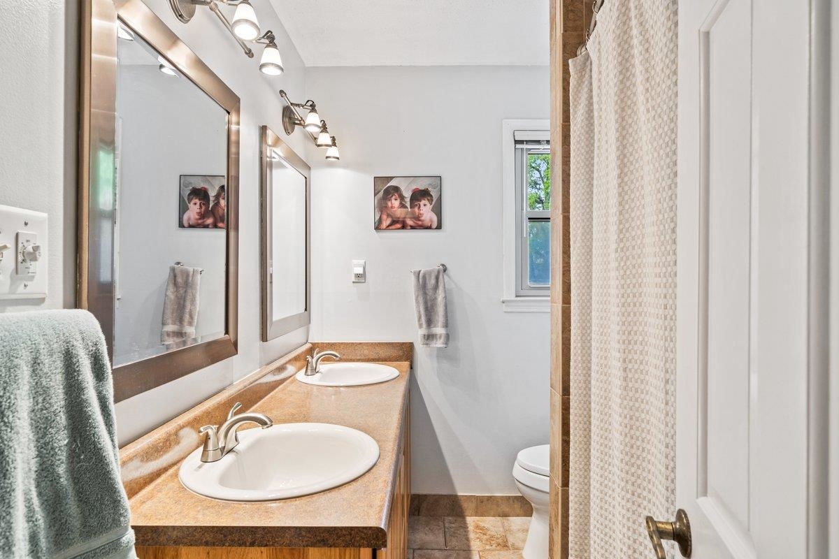 2135 Brierbrook Road Germantown, TN 38138 - Photo 20 of 25 Bathroom with double vanity and a shower with shower curtain
