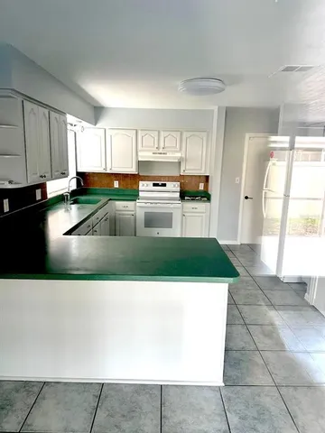 a kitchen with a cabinets a counter top space and a sink