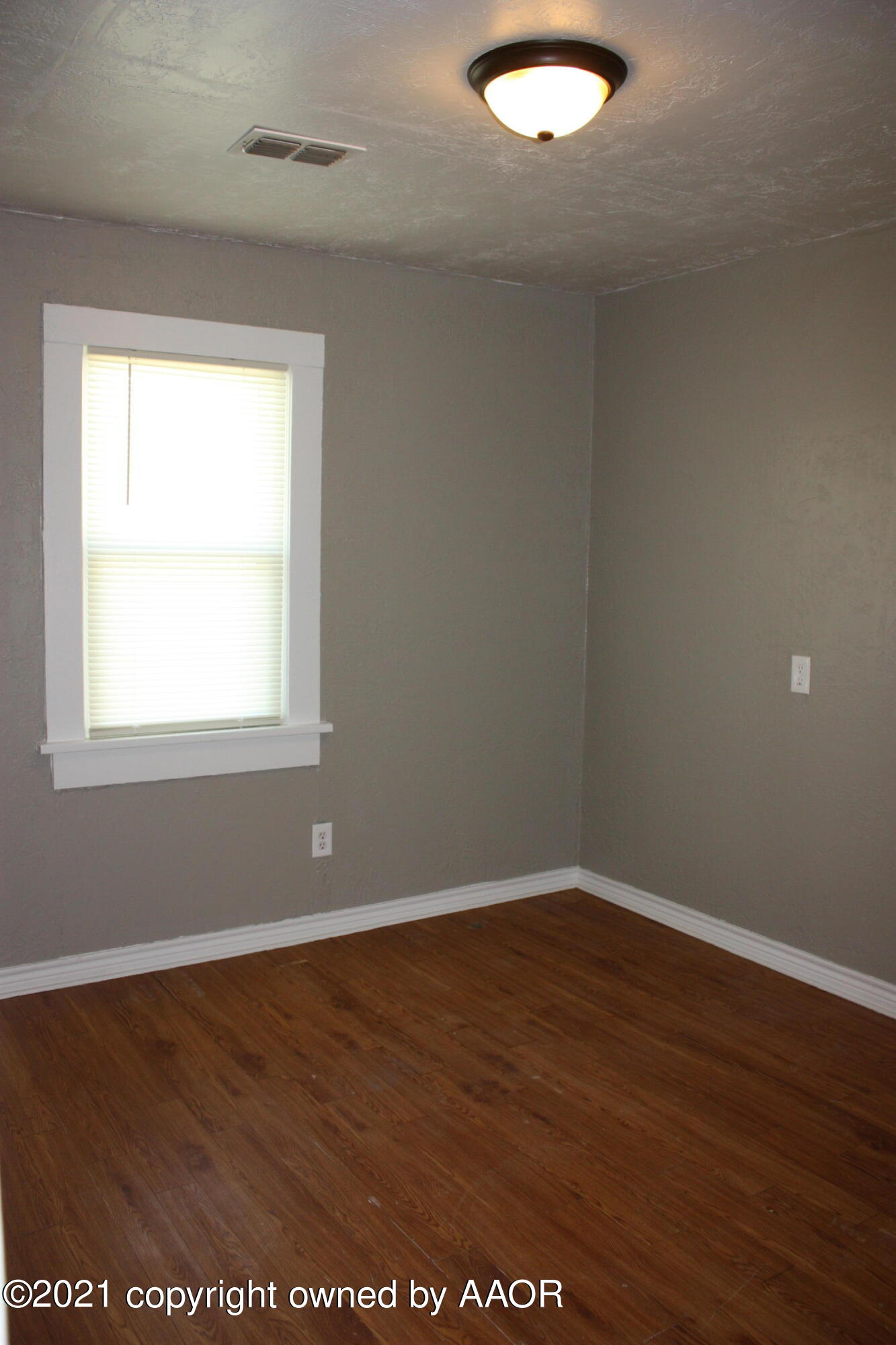 3905 South Tyler Street Amarillo, TX 79110 - Photo 26 of 35 an empty room with wooden floor and windows