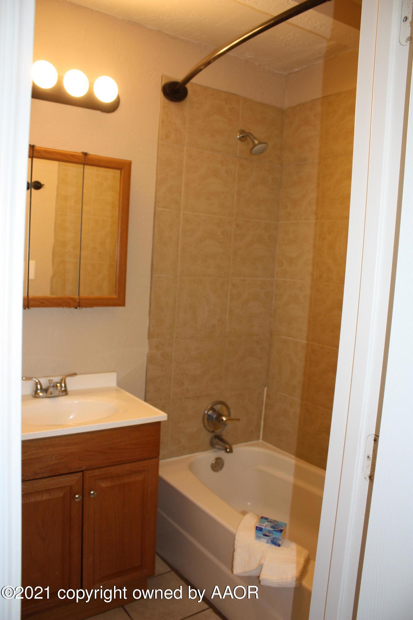 3905 South Tyler Street Amarillo, TX 79110 - Photo 31 of 35 a bathroom with a sink a toilet and a mirror