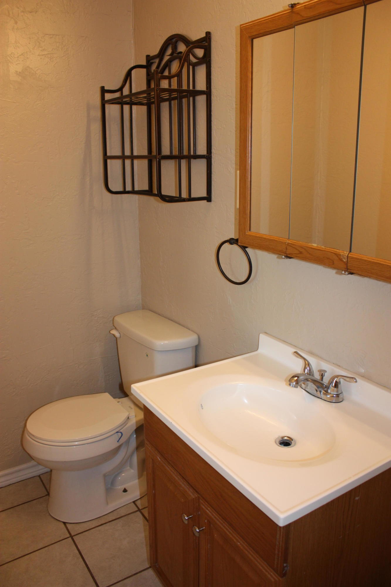 3905 South Tyler Street Amarillo, TX 79110 - Photo 33 of 35 a bathroom with a toilet sink and mirror