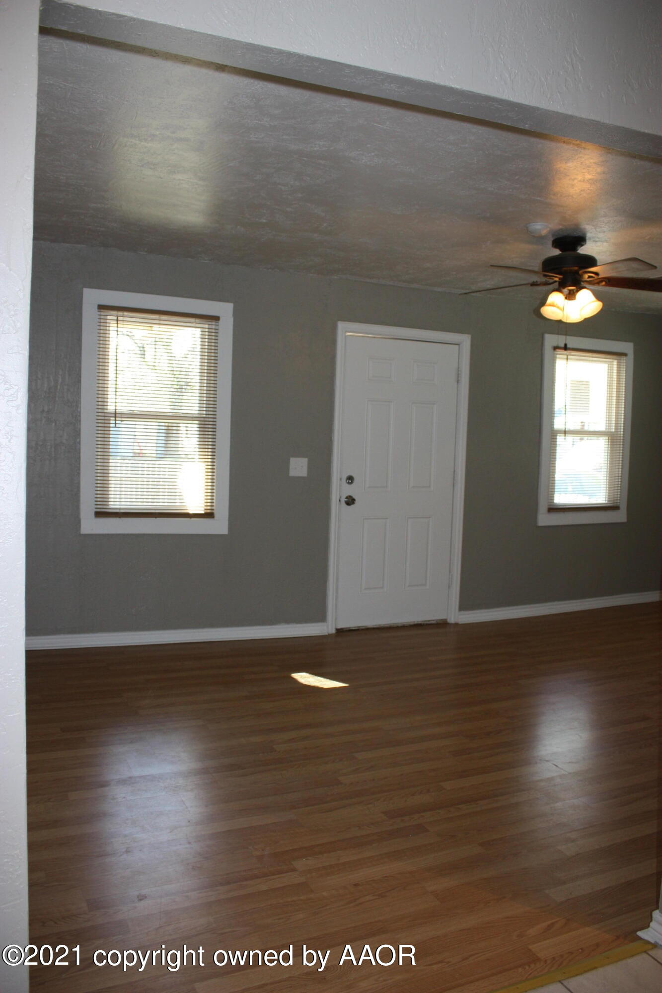 3905 South Tyler Street Amarillo, TX 79110 - Photo 9 of 35 a view of an empty room with window and wooden floor
