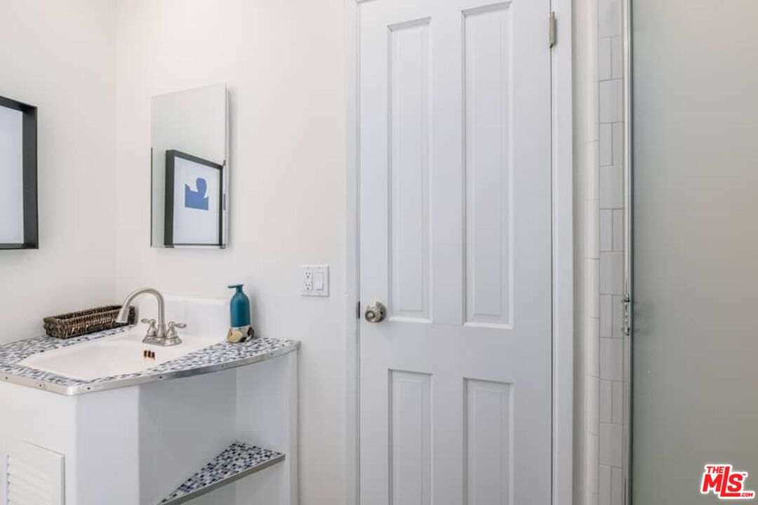 2841 Roscomare Road Los Angeles, CA 90077 - Photo 14 of 28 a bathroom with a sink and a mirror