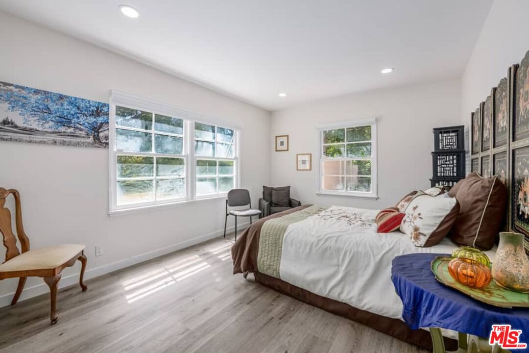 2841 Roscomare Road Los Angeles, CA 90077 - Photo 15 of 28 a bedroom with a bed and wooden floor